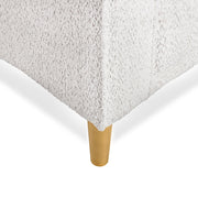 Right facing close up of the leg and upholstery of a contemporary off-white metallic boucle loveseat on a white background