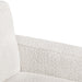 Right facing close up of the inner armrest of a contemporary off-white metallic boucle sofa on a white background