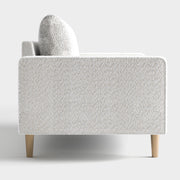 Front facing side view of a contemporary off-white metallic boucle sofa on a white background