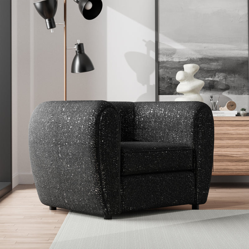 Right facing contemporary black metallic boucle shelter armchair in a room with accessories