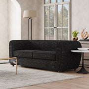 Left facing contemporary black metallic boucle shelter sofa in a room with accessories