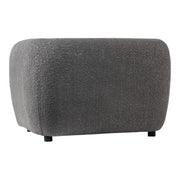 Right facing side view of a contemporary charcoal gray metallic boucle shelter armchair on a white background