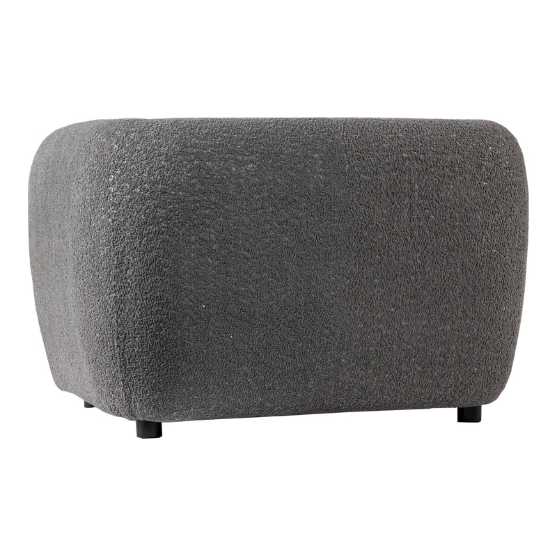 Right facing side view of a contemporary charcoal gray metallic boucle shelter armchair on a white background