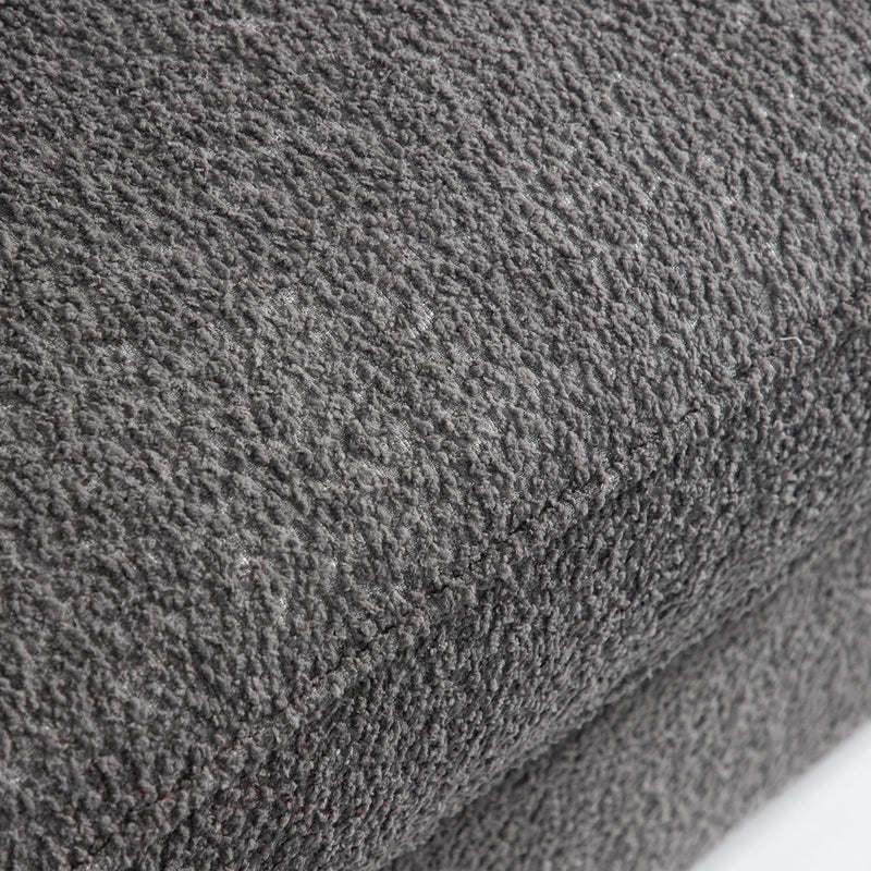 Right facing close up of the seat cushion of a contemporary charcoal gray metallic boucle shelter loveseat on a white background