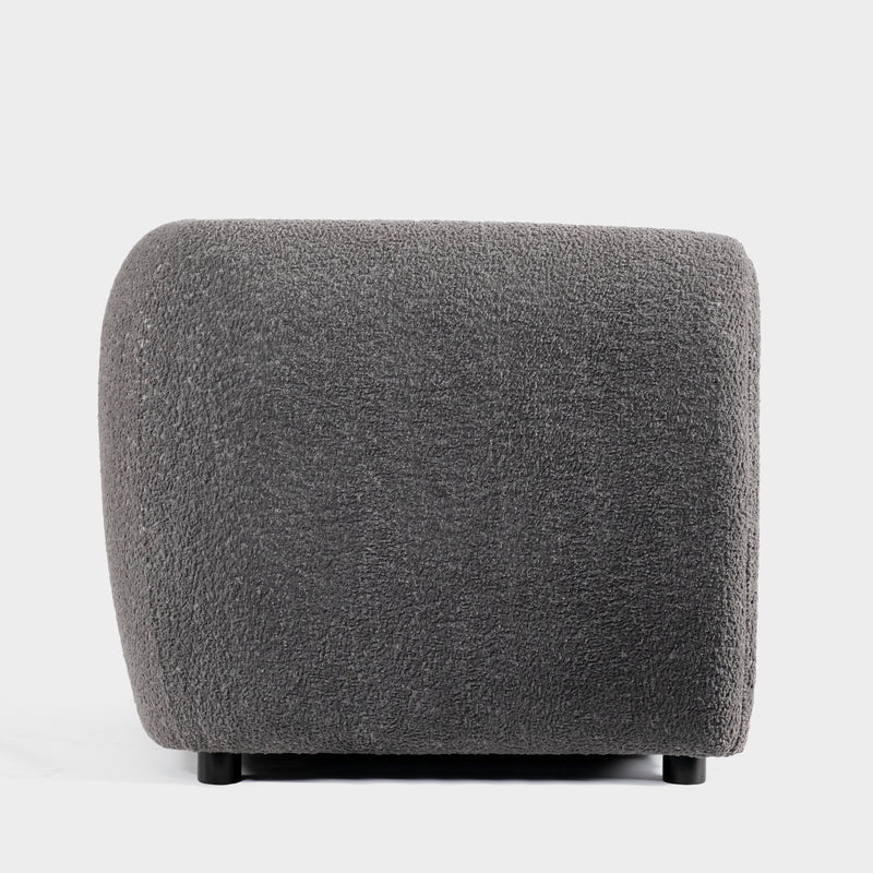 Front facing side view of a contemporary charcoal gray metallic boucle shelter loveseat on a white background