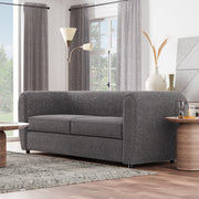 Left facing contemporary charcoal gray metallic boucle shelter sofa in a room with accessories