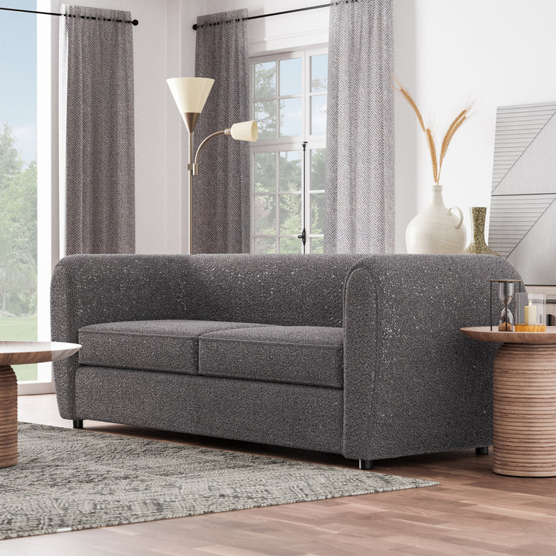 Left facing contemporary charcoal gray metallic boucle shelter sofa in a room with accessories