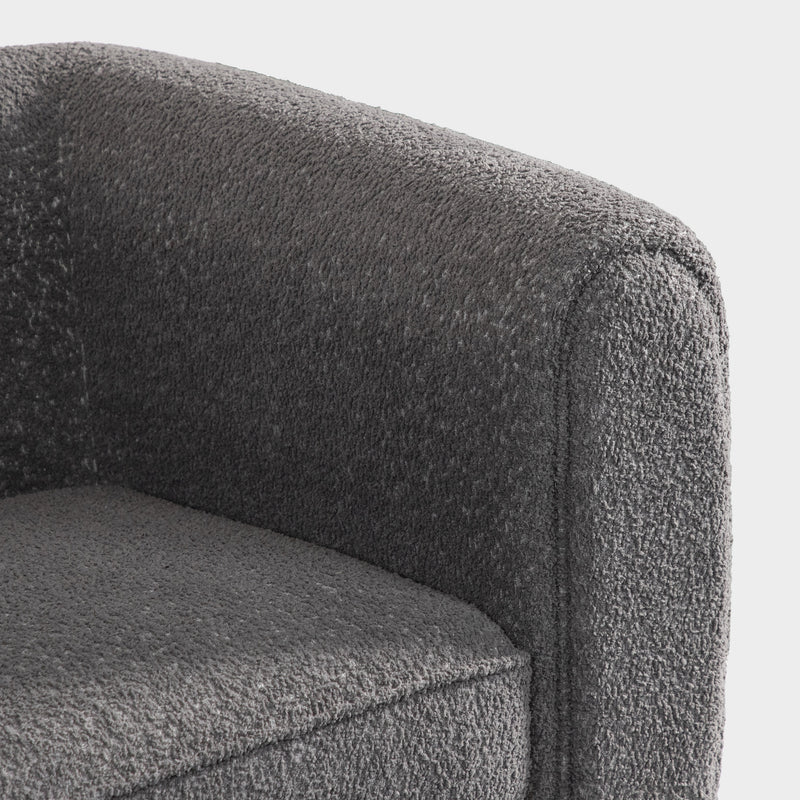 Right facing close up of the inner armrest of a contemporary charcoal gray metallic boucle shelter sofa on a white background
