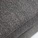 Right facing close up of the seat cushion of a contemporary charcoal gray metallic boucle shelter sofa on a white background