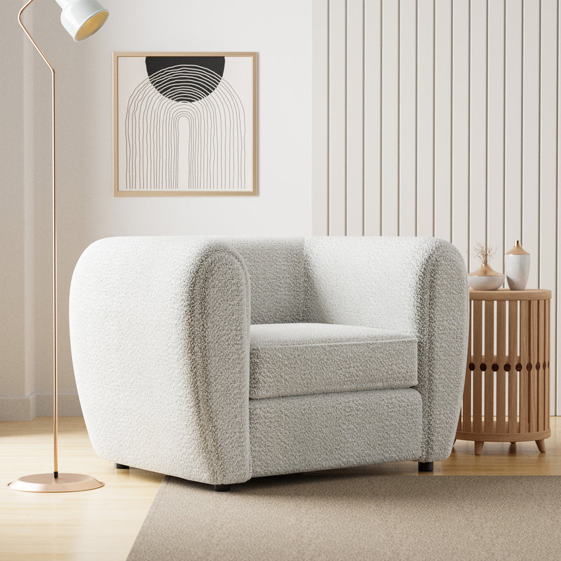 Right facing contemporary off-white metallic boucle shelter armchair in a room with accessories