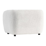 Right facing side view of a contemporary off-white metallic boucle shelter armchair on a white background