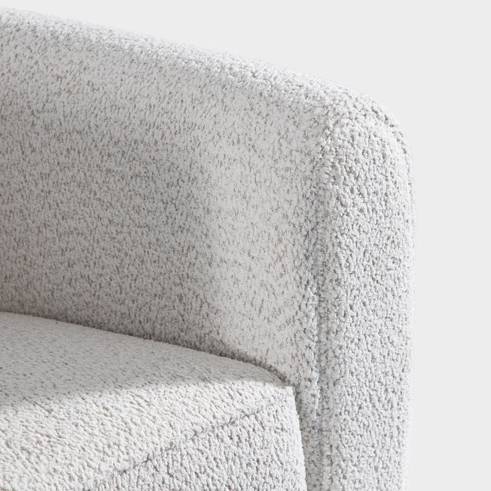 Right facing close up of the inner armrest of a contemporary off-white metallic boucle shelter loveseat on a white background