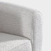 Right facing close up of the inner armrest of a contemporary off-white metallic boucle shelter loveseat on a white background