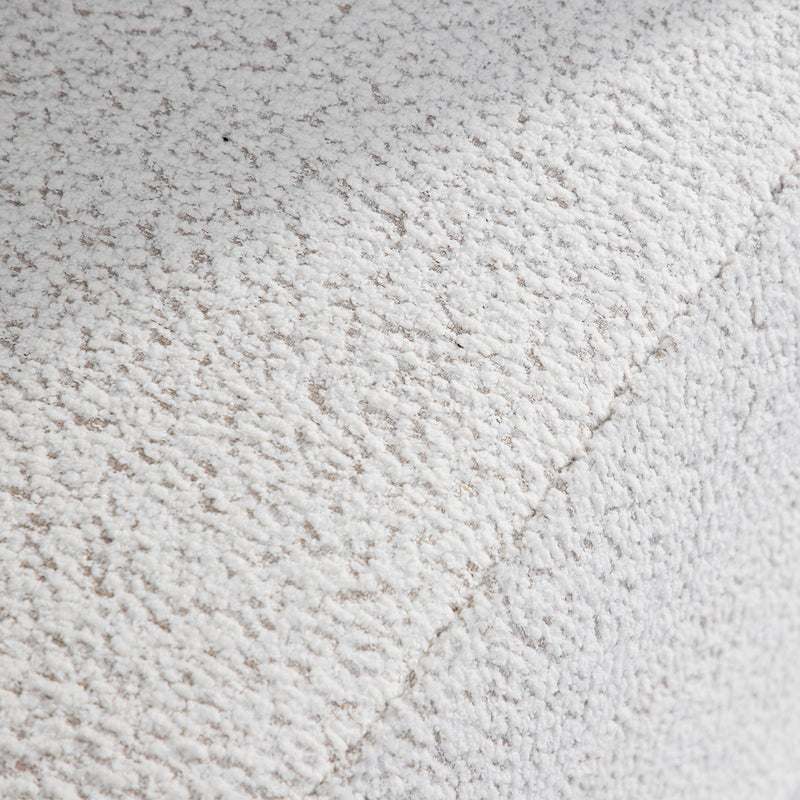 Swatch of the upholstery fabric on a contemporary off-white metallic boucle shelter loveseat