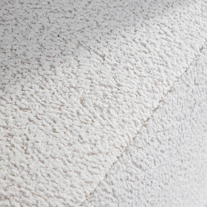 Swatch of the upholstery fabric on a contemporary off-white metallic boucle shelter loveseat
