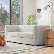 Left facing contemporary off-white metallic boucle shelter sofa in a room with accessories
