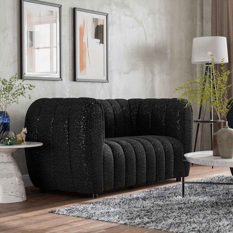 Right facing contemporary black and metallic boucle tufted shelter loveseat in a living room with accessories