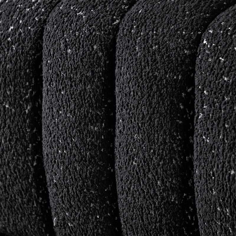 Front facing close up upholstery and tufting of a contemporary black and metallic boucle tufted shelter loveseat