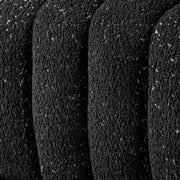 Front facing close up upholstery and tufting of a contemporary black and metallic boucle tufted shelter sofa