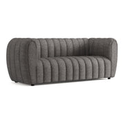 Right facing contemporary charcoal gray and metallic boucle tufted shelter sofa on a white background
