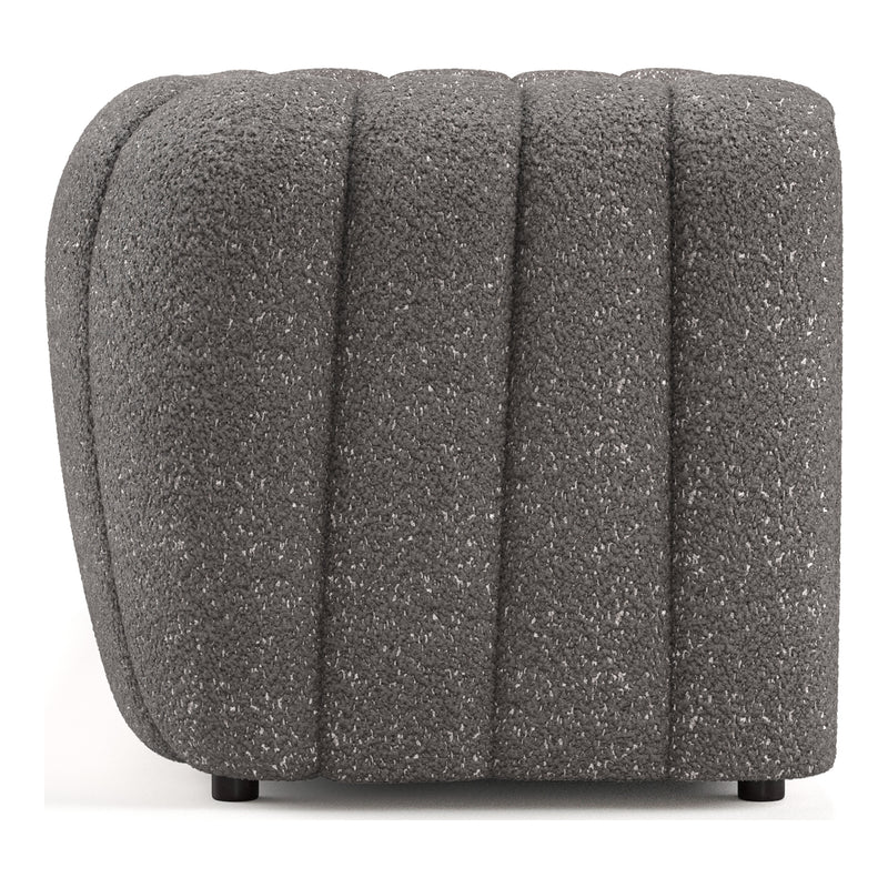 Front facing side view of a contemporary charcoal gray and metallic boucle tufted shelter sofa on a white background