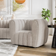 Left facing contemporary off-white metallic boucle tufted shelter armchair in a room with accessories