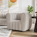 Left facing contemporary off-white metallic boucle tufted shelter armchair in a room with accessories