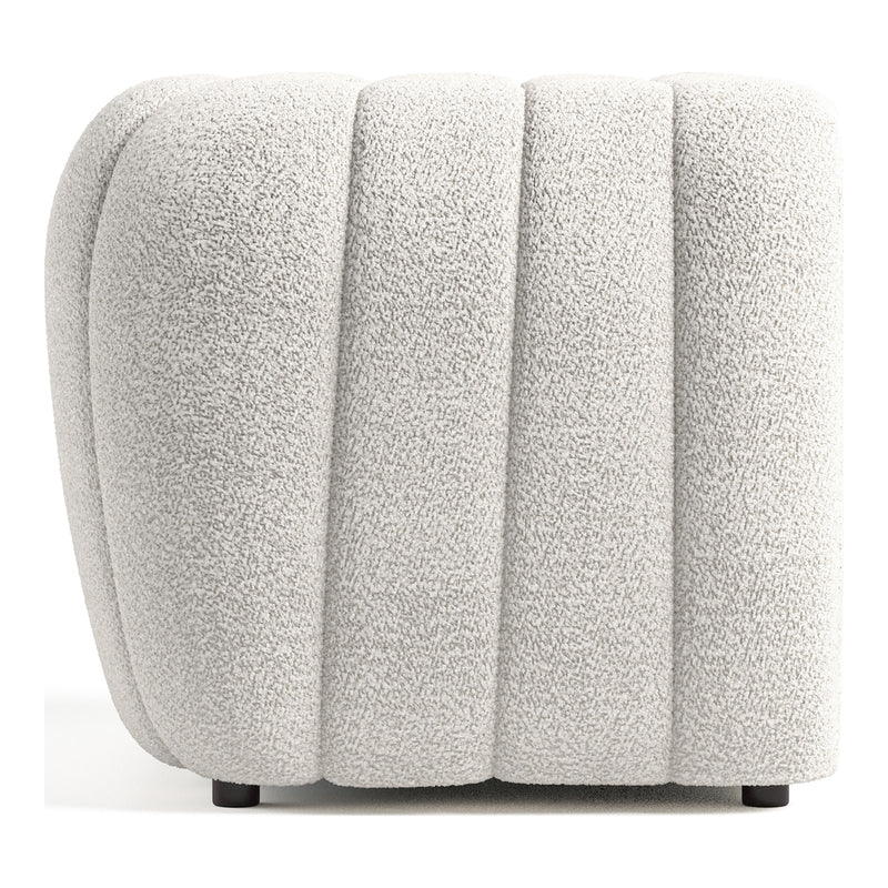 Front facing side view of a contemporary off-white metallic boucle tufted shelter armchair on a white background