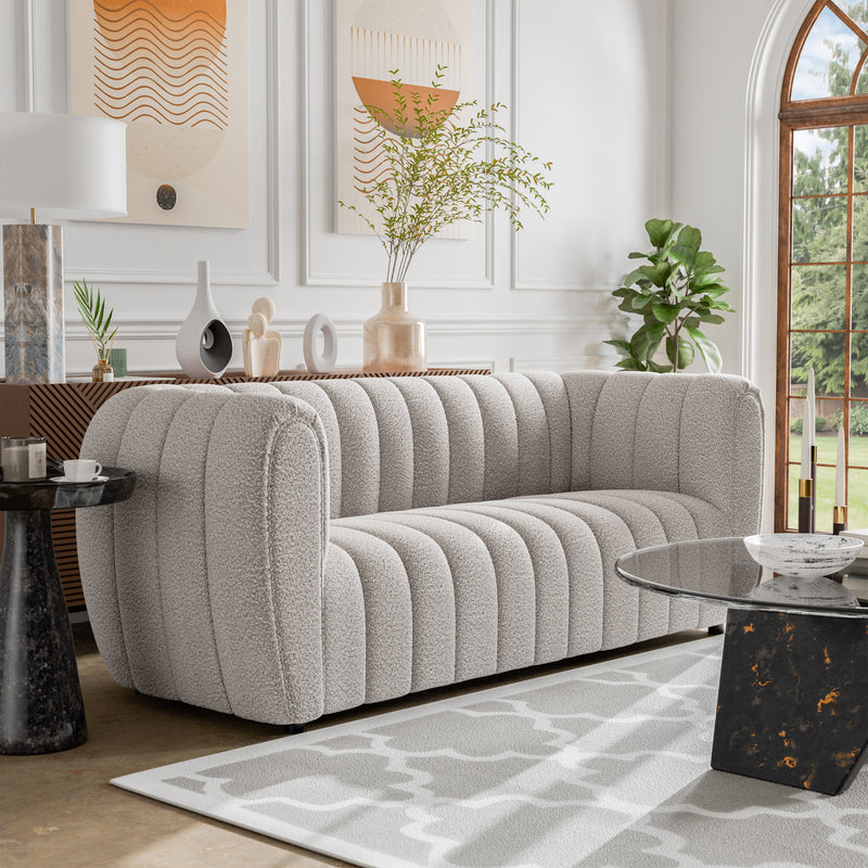 Right facing contemporary off-white metallic boucle tufted shelter sofa in a room with accessories