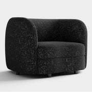 Right facing contemporary black and metallic boucle curved kidney armchair on a white background