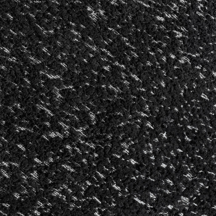 Swatch of the upholstery fabric on a contemporary black and metallic boucle curved kidney loveseat 