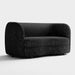 Right facing contemporary black and metallic boucle curved kidney loveseat on a white background