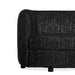 Front facing close up view of the leg and armrest on a contemporary black and metallic boucle curved kidney loveseat