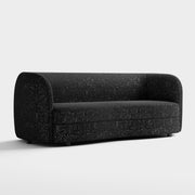 Right facing contemporary black and metallic boucle curved kidney sofa on a white background