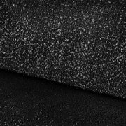 Left facing close up view of the upholstery on a contemporary black and metallic boucle curved kidney sofa