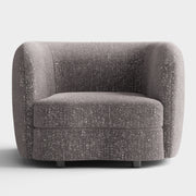 Front facing contemporary charcoal gray and metallic boucle curved kidney armchair on a white background