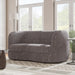 Left facing contemporary charcoal gray and metallic boucle curved kidney loveseat in a room with accessories