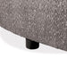 Left facing close up view of the leg on a contemporary charcoal gray and metallic boucle curved kidney loveseat on a white background