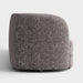 Front facing side view of a contemporary charcoal gray and metallic boucle curved kidney loveseat on a white background