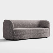 Right facing contemporary charcoal gray and metallic boucle curved kidney sofa on a white background