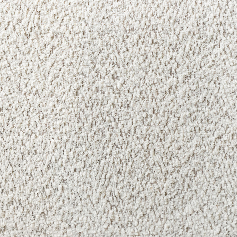 Swatch of the upholstery fabric on a contemporary off-white metallic boucle curved kidney armchair