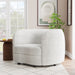 Left facing contemporary off-white metallic boucle curved kidney armchair in a room with accessories