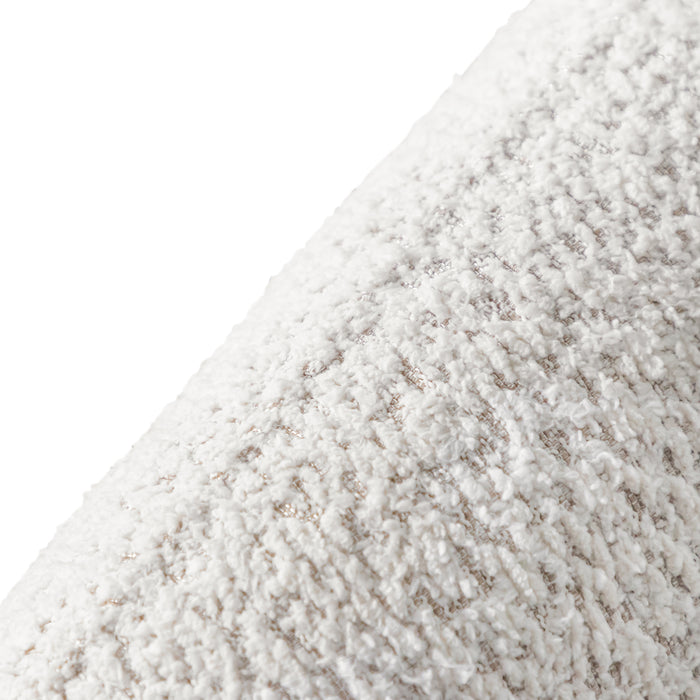 Right facing close up view of the upholstery and back on a contemporary off-white metallic boucle curved kidney armchair on a white background