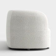 Front facing side view of a contemporary off-white metallic boucle curved kidney armchair on a white background