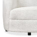 Front facing close up view of the upholstery and leg on a contemporary off-white metallic boucle curved kidney loveseat on a white background