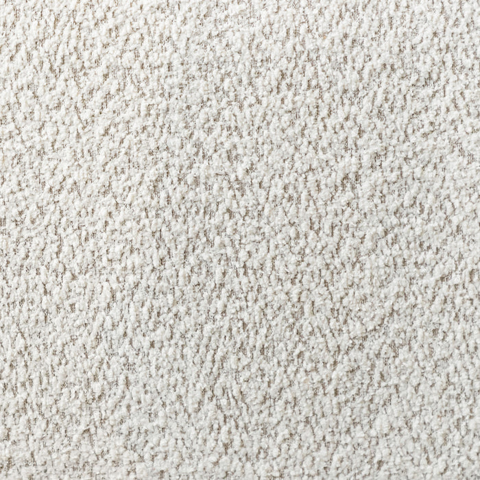 Swatch of the upholstery fabric on a contemporary off-white metallic boucle curved kidney sofa