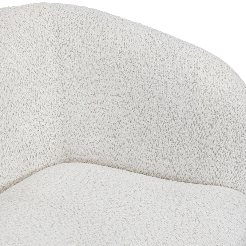 Right facing close up view of the inner armrest on a contemporary off-white metallic boucle curved kidney sofa on a white background
