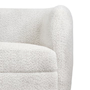 Front facing close up view of the upholstery and armrest on a contemporary off-white metallic boucle curved kidney sofa on a white background
