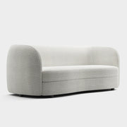 Right facing contemporary off-white metallic boucle curved kidney sofa on a white background