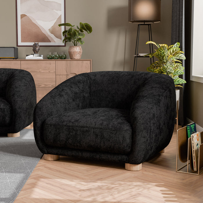 Left facing contemporary black chenille sloping tuxedo accent armchair in a room with accessories
